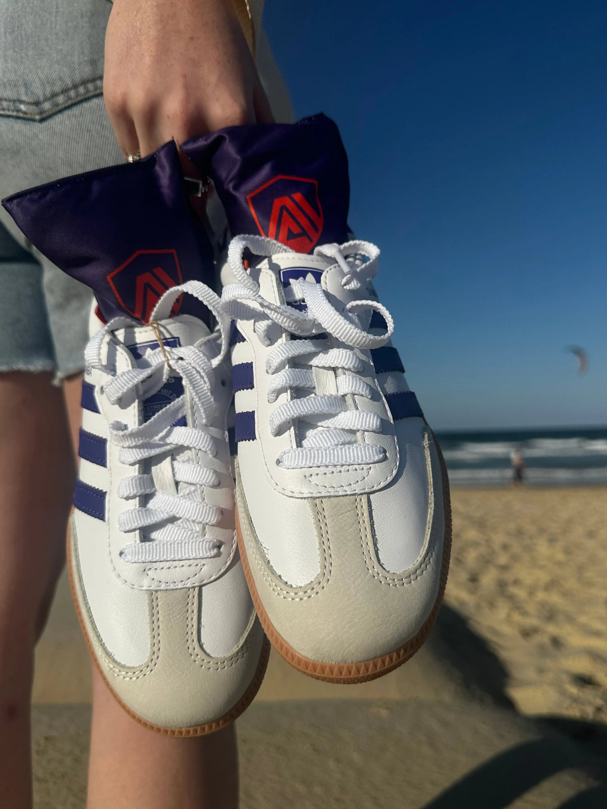 Ocean Breeze Aroma Armour Shoe Fresheners in Adidas Gazelle shoes being carried at a beach