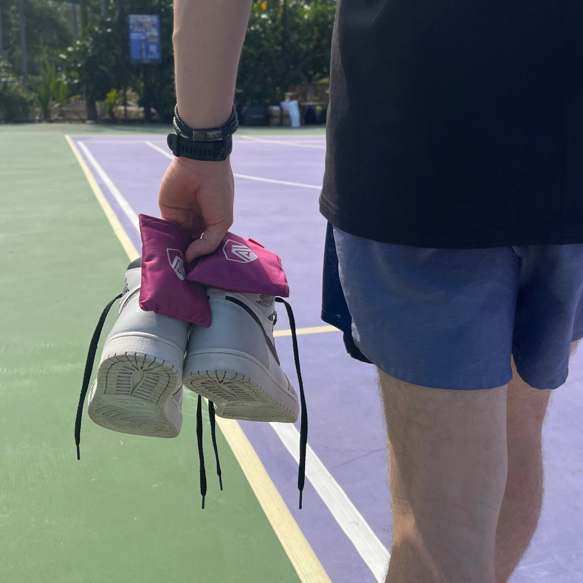Sandalwood Aroma Armour Shoe Fresheners being carried with Jordans across basketball court